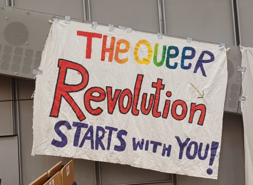 Banner the Queer Revolution starts with you